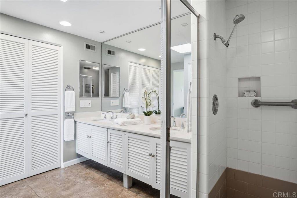 213 Via Osuna Rancho Santa Fe, CA 92091 - Photo 33 of 58 a bathroom with a double vanity sink a mirror and shower