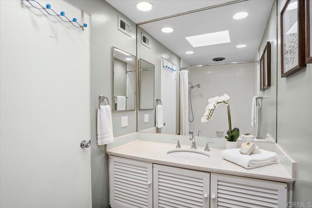 213 Via Osuna Rancho Santa Fe, CA 92091 - Photo 38 of 58 a bathroom with a sink and a mirror