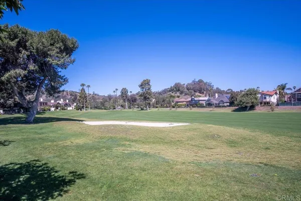 a view of a swimming pool with a yard