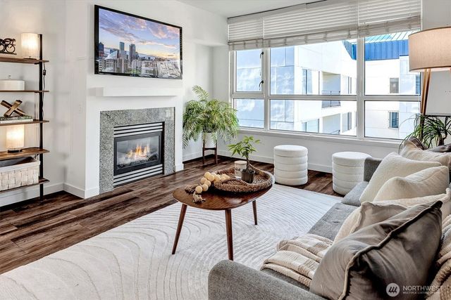a living room with furniture a flat screen tv and a fireplace