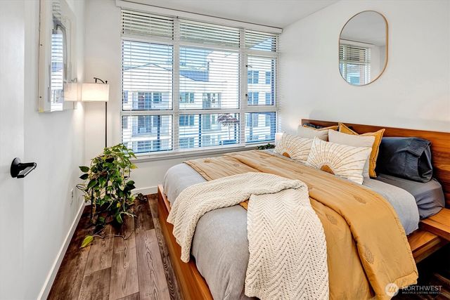 a bed sitting in a bedroom next to a window