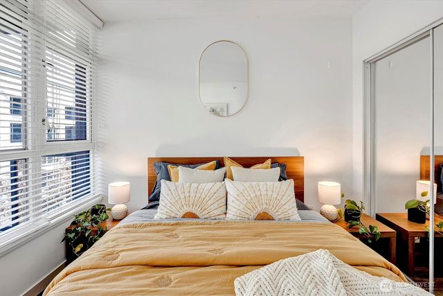 a bedroom with bed and a window