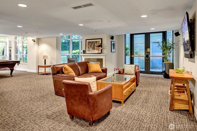 a living room with furniture and a large window