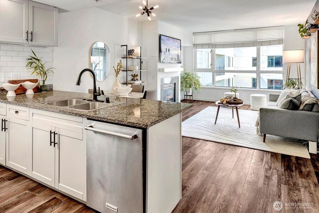 a kitchen with sink and view of living room