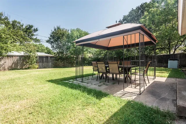 a view of a chair and table in the garden