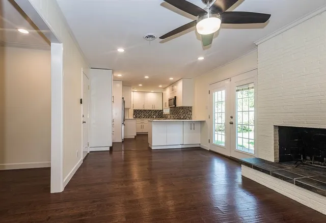 a view of kitchen with livingroom and wooden floor