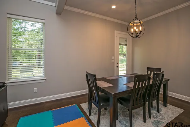 a view of a dining room with furniture and window