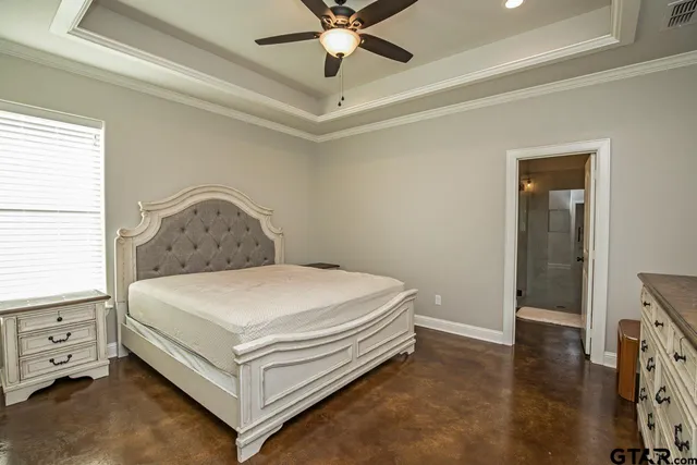 a bed sitting in a bedroom next to a window