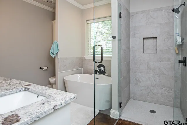 a bathroom with a tub and shower
