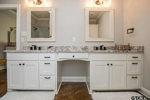 a bathroom with a sink vanity and mirror