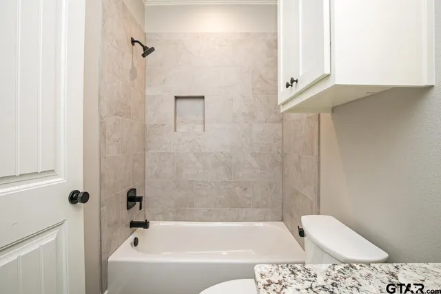 a bathroom with a bathtub and shower