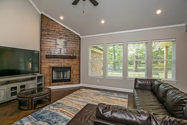 a living room with furniture flat screen tv and a fireplace