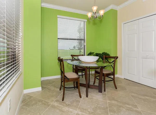 a view of a dining room with furniture and a chandelier