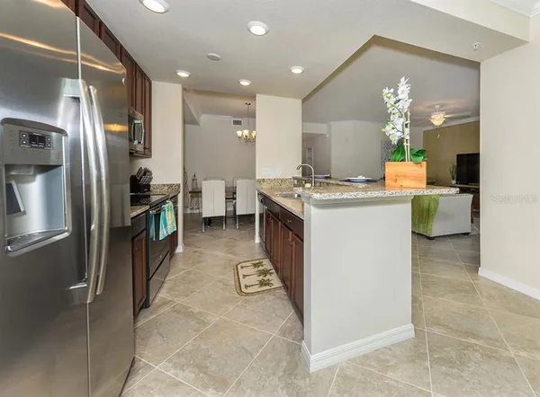 a kitchen with stainless steel appliances granite countertop a refrigerator and a stove