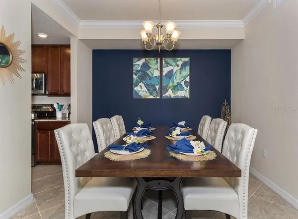 a bedroom with a bed mirror and window