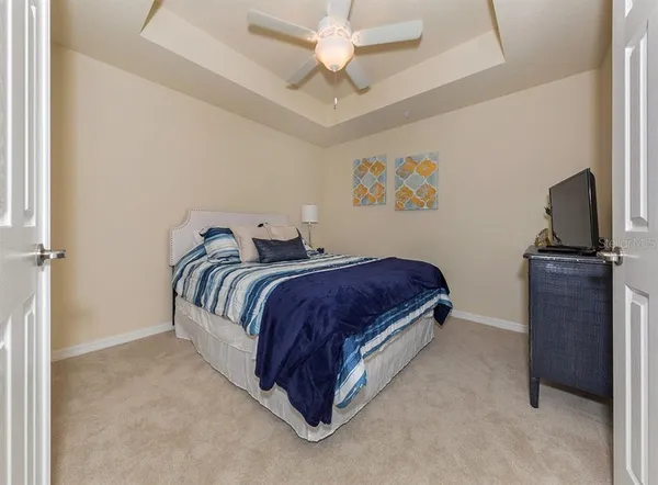 a bedroom with a bed and a television
