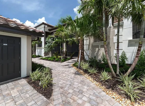 a view of a patio with table and chairs and potted plants