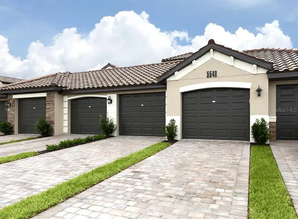 a view of a backyard with a table and chairs