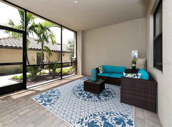 a living room with a large window and a rug