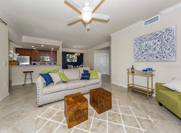 a living room with furniture and kitchen view