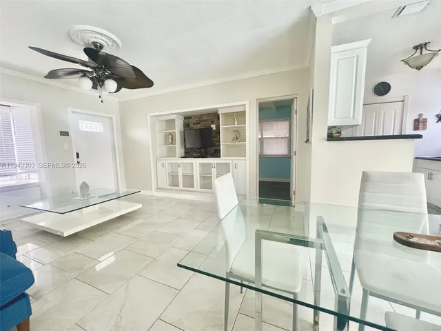 a view of a living room and kitchen with a sink