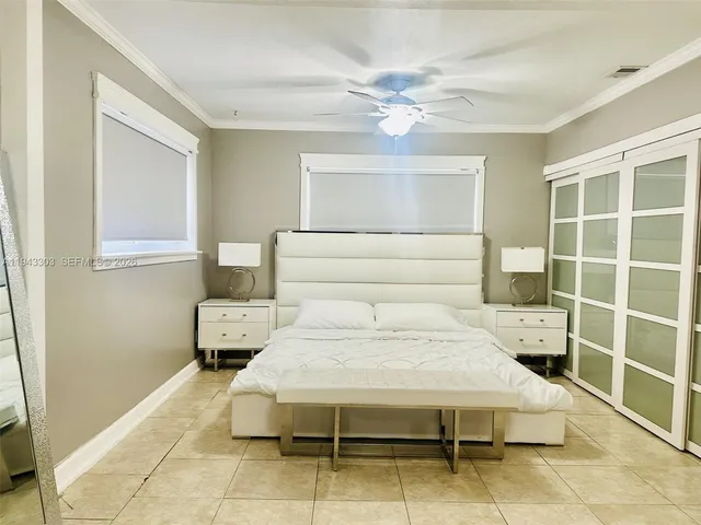 a bedroom with a bed and ceiling fan