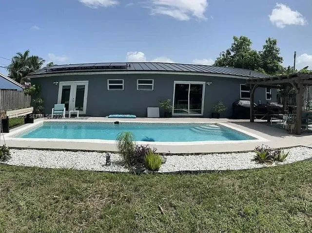 a front view of a house with a porch and a yard