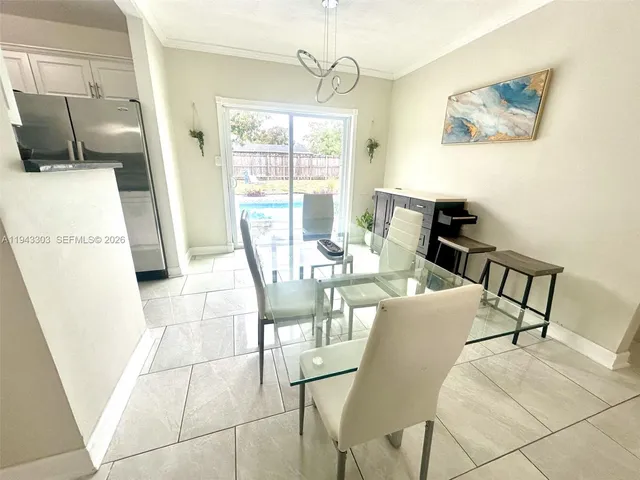 a dining room with furniture and window