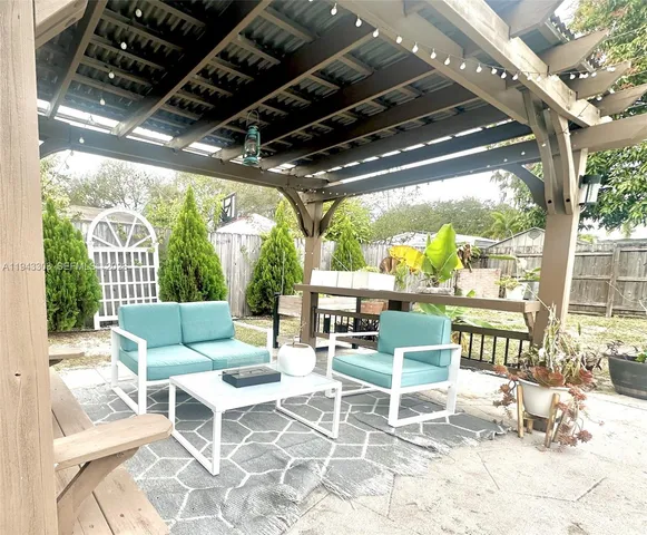 a building outdoor space with patio furniture and potted plants