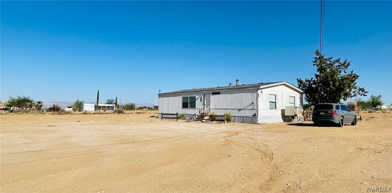 458 South Hope Road Golden Valley, AZ 86413 - Photo 1 of 27 a view of a house with a patio and a yard
