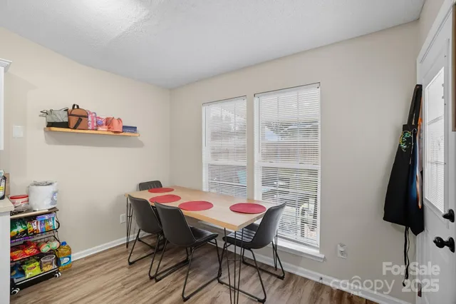 a view of a dining room with furniture and a window