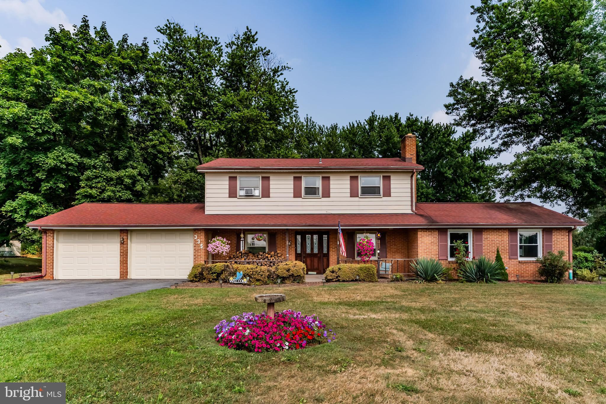 335 Wolfs Bridge Road Carlisle, PA 17013 - Photo 1 of 37 a front view of a house with garden
