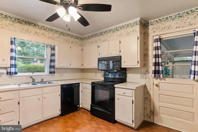 a kitchen with a stove sink and cabinets