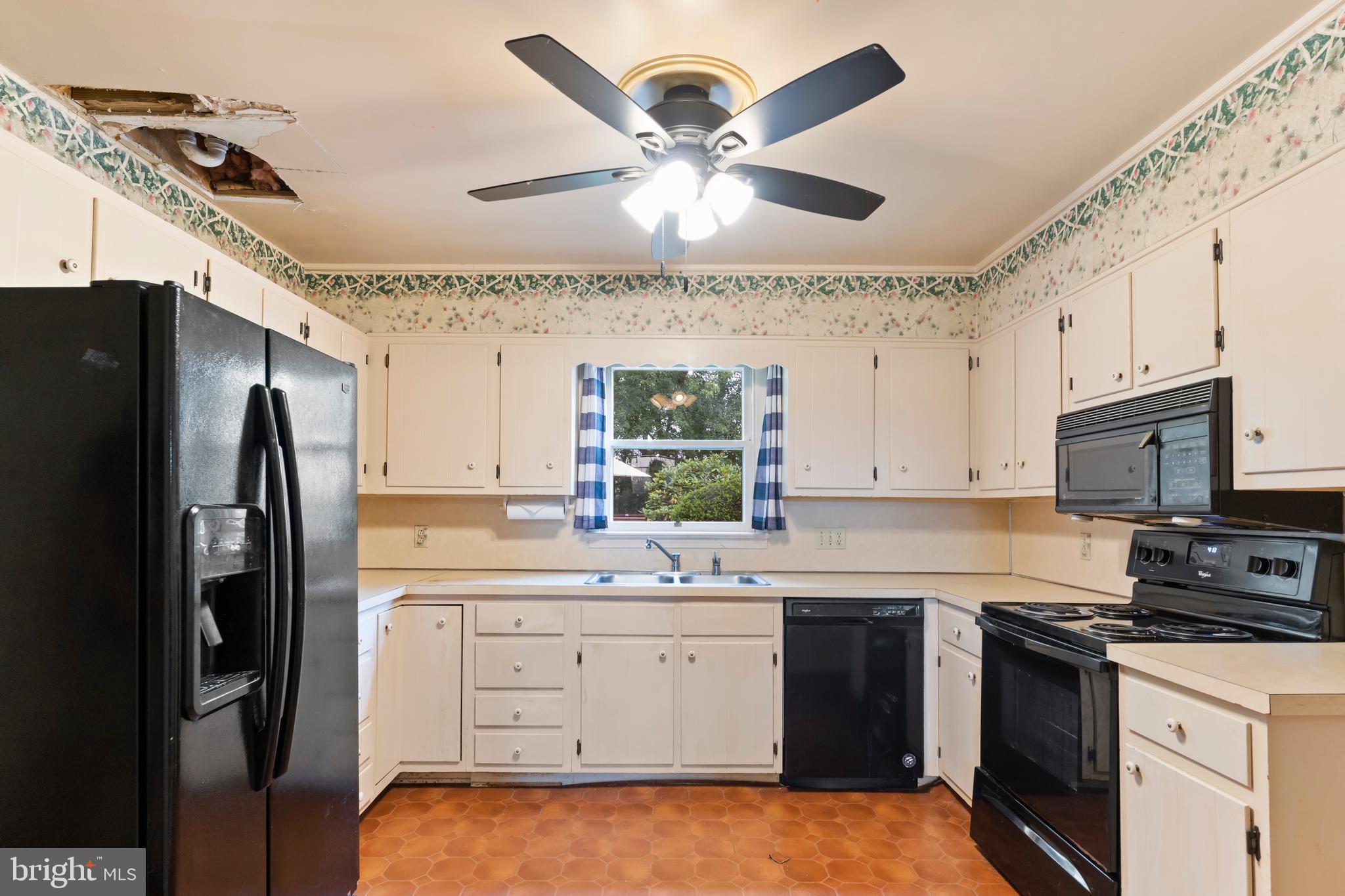 335 Wolfs Bridge Road Carlisle, PA 17013 - Photo 14 of 37 a kitchen with a sink stainless steel appliances and white cabinets