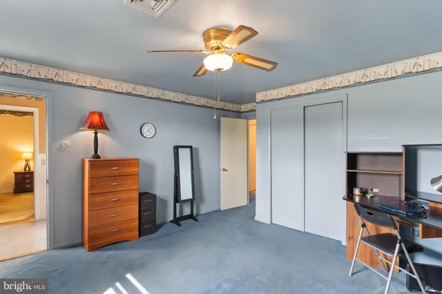 a view of a livingroom with furniture and a ceiling fan