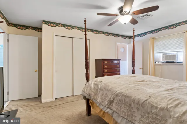 a spacious bedroom with a bed and a chandelier