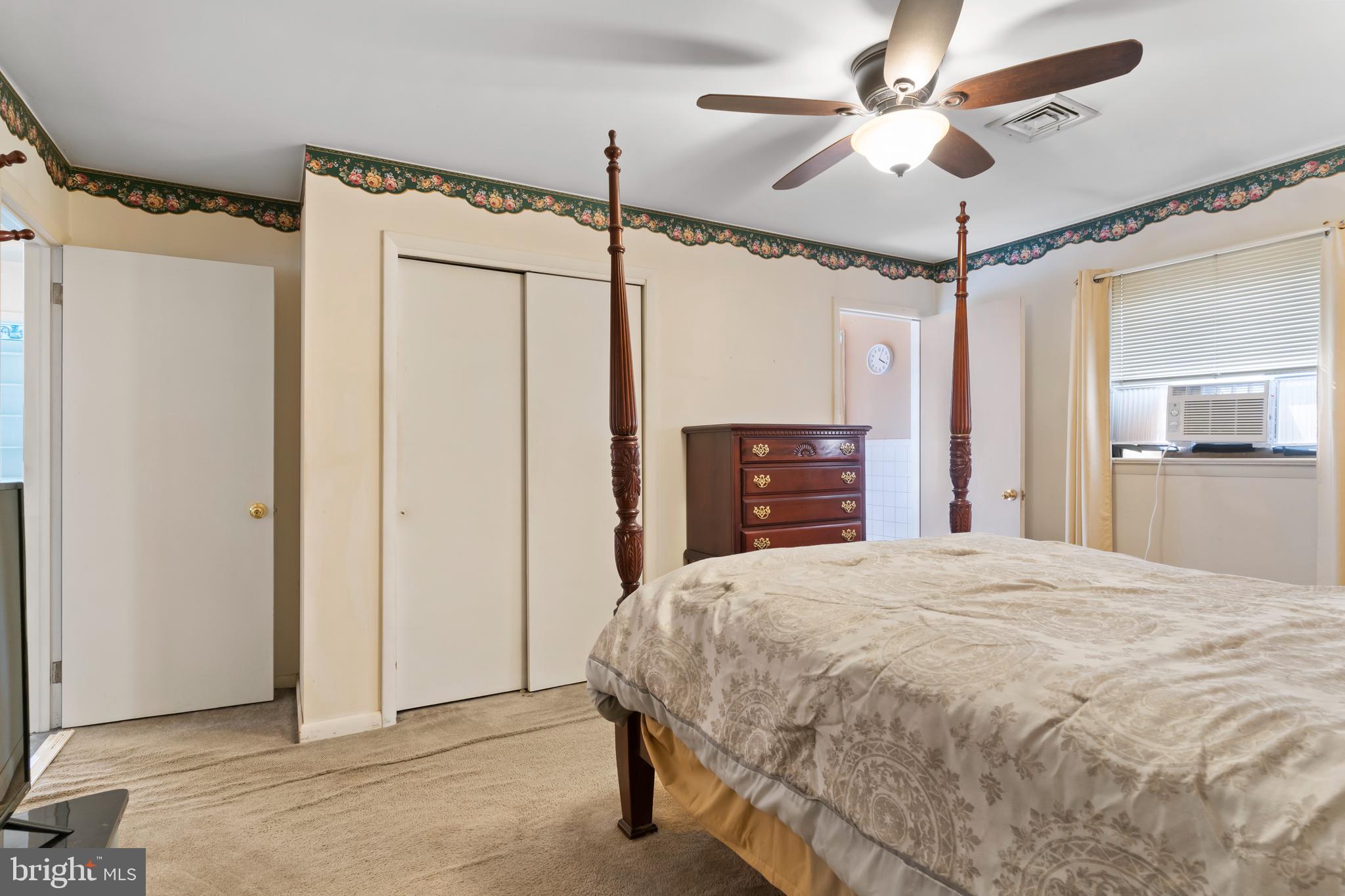 335 Wolfs Bridge Road Carlisle, PA 17013 - Photo 19 of 37 a spacious bedroom with a bed and a chandelier