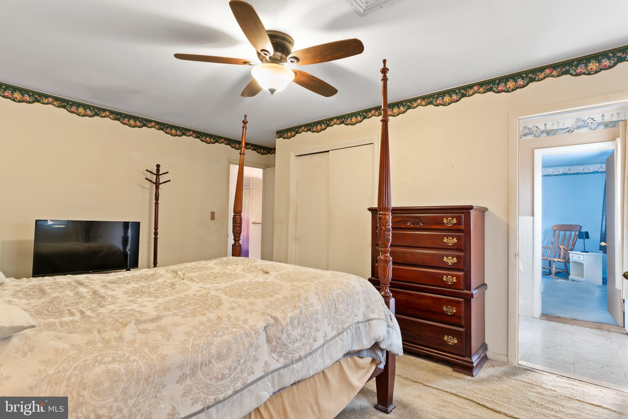 335 Wolfs Bridge Road Carlisle, PA 17013 - Photo 20 of 37 a bedroom with a bed a dresser and a flat screen tv