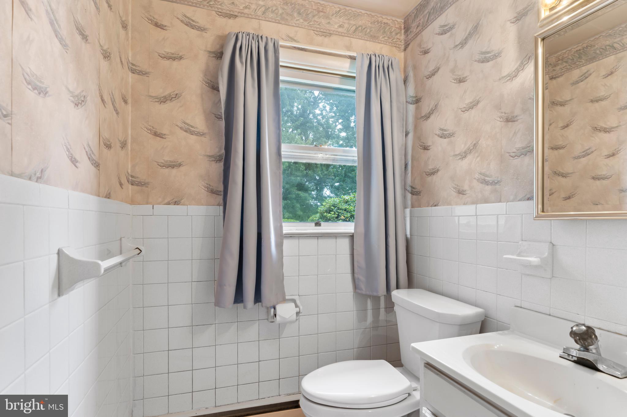 335 Wolfs Bridge Road Carlisle, PA 17013 - Photo 24 of 37 a white toilet sitting next to a bathroom sink