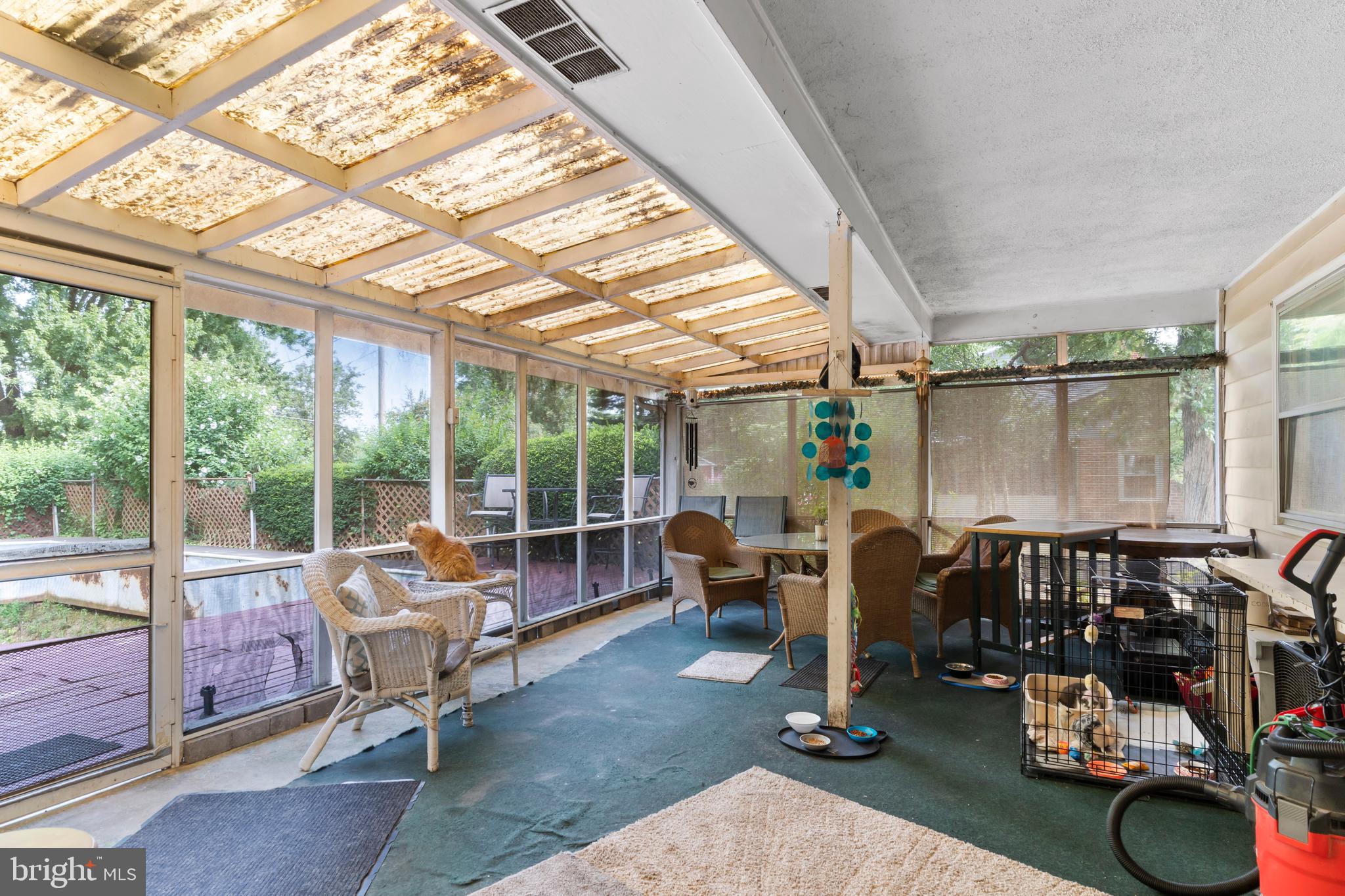 335 Wolfs Bridge Road Carlisle, PA 17013 - Photo 29 of 37 a living room with patio furniture and a floor to ceiling window