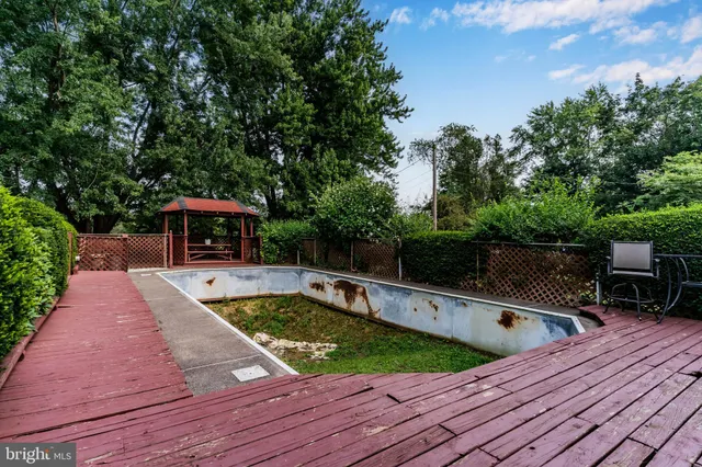 swimming pool view with sitting space and garden view