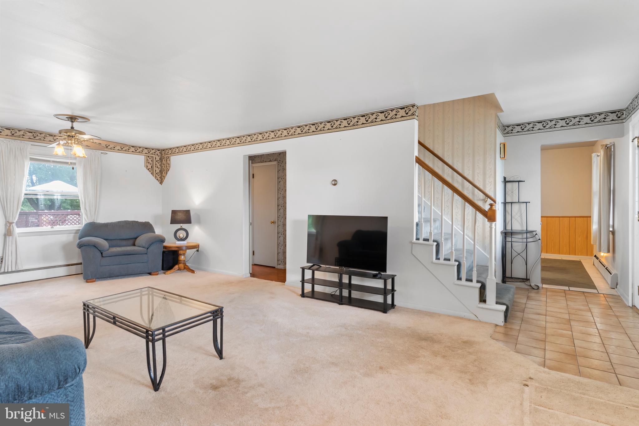 335 Wolfs Bridge Road Carlisle, PA 17013 - Photo 5 of 37 a living room with furniture a flat screen tv and a window