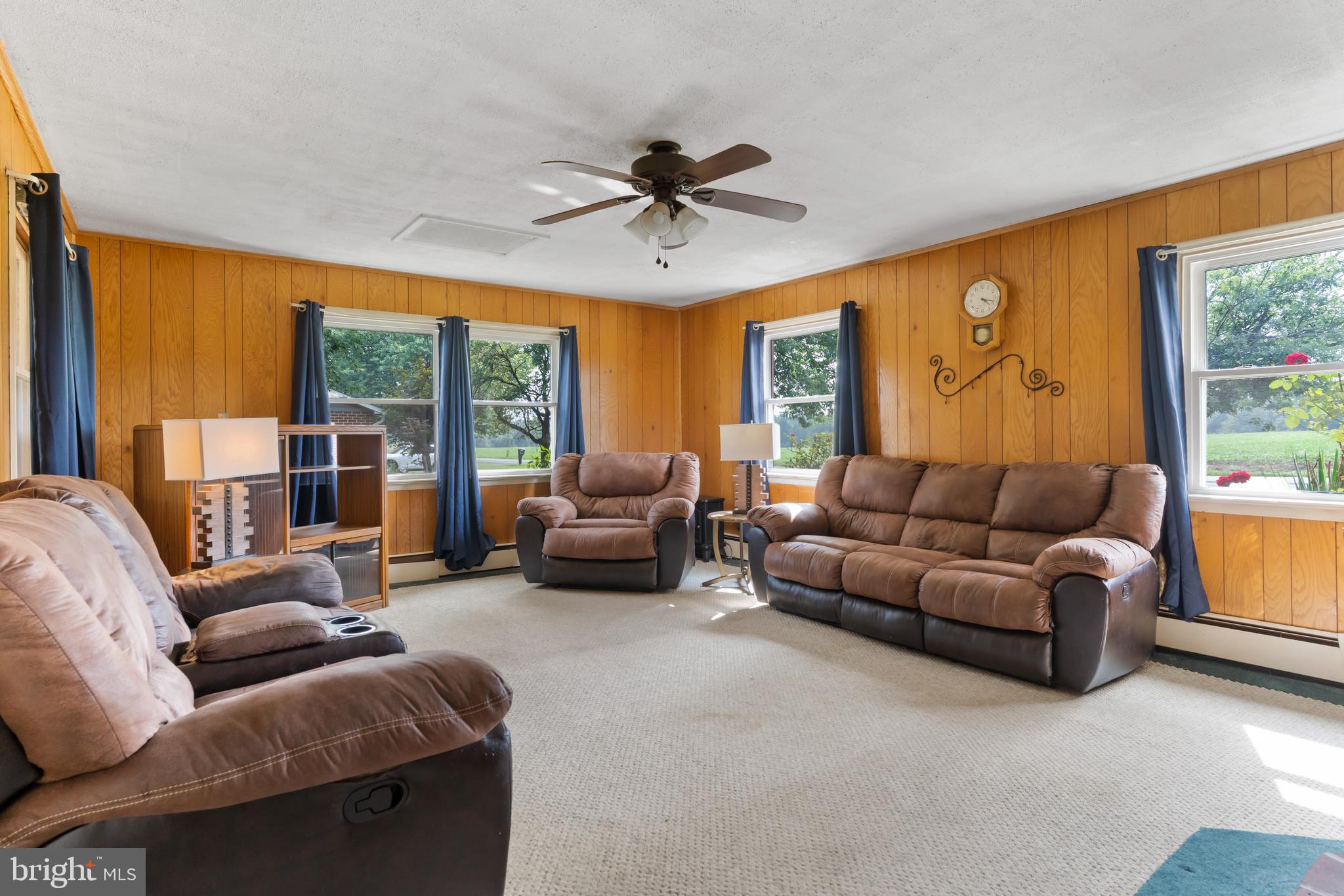 335 Wolfs Bridge Road Carlisle, PA 17013 - Photo 7 of 37 a living room with furniture ceiling fan and a large window