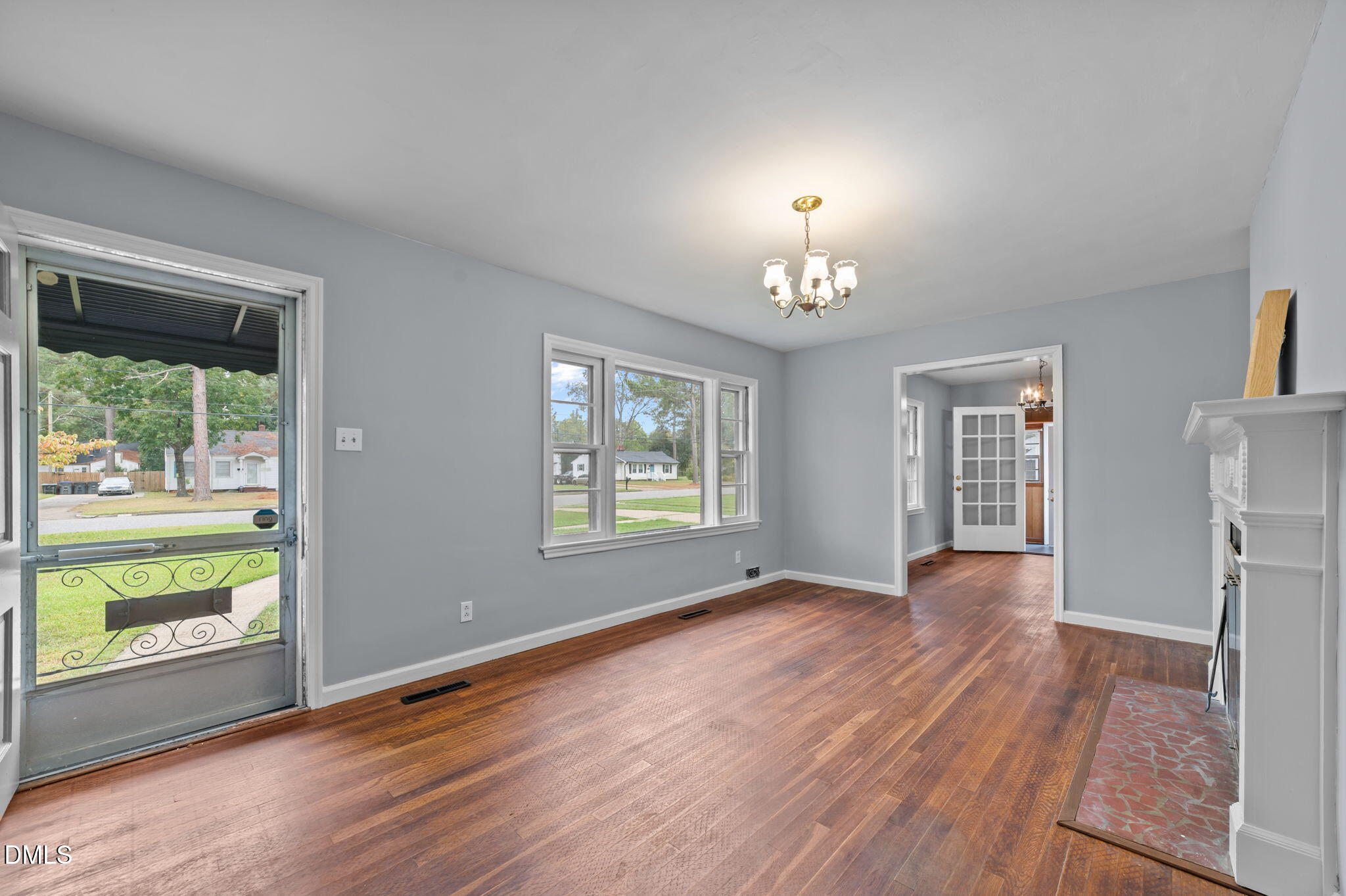 1220 Tarboro Street Rocky Mount, NC 27801 - Photo 17 of 47 a view of an empty room with a window and wooden floor