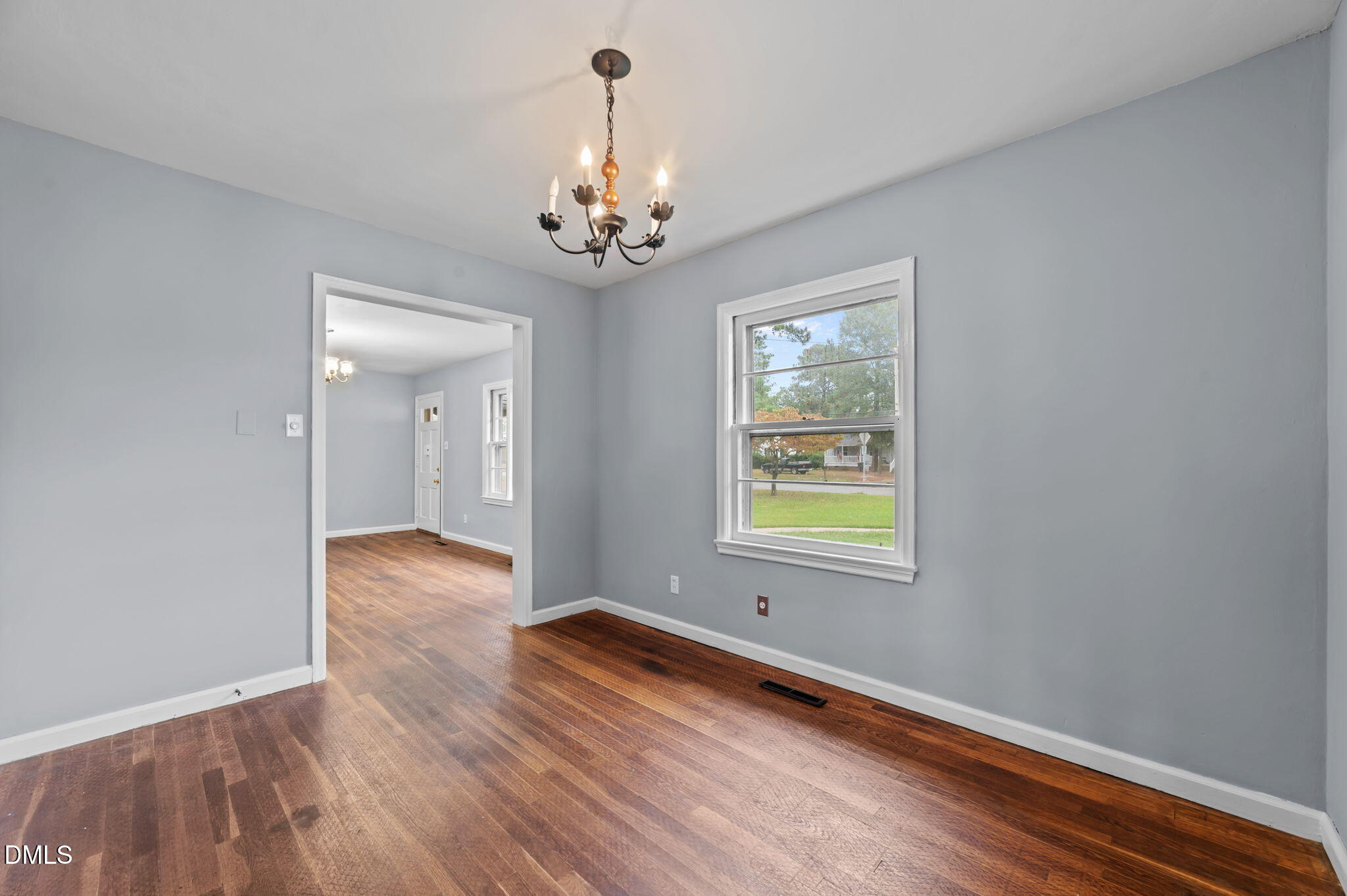 1220 Tarboro Street Rocky Mount, NC 27801 - Photo 21 of 47 an empty room with wooden floor and windows