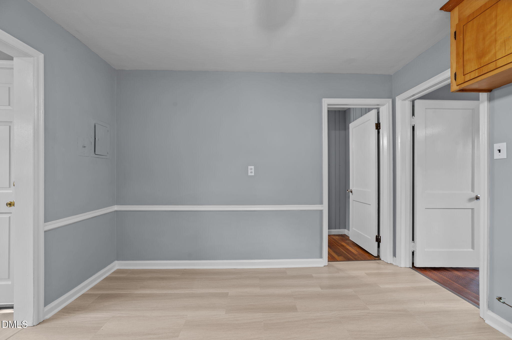 1220 Tarboro Street Rocky Mount, NC 27801 - Photo 27 of 47 a view of an empty room with wooden floor and a window