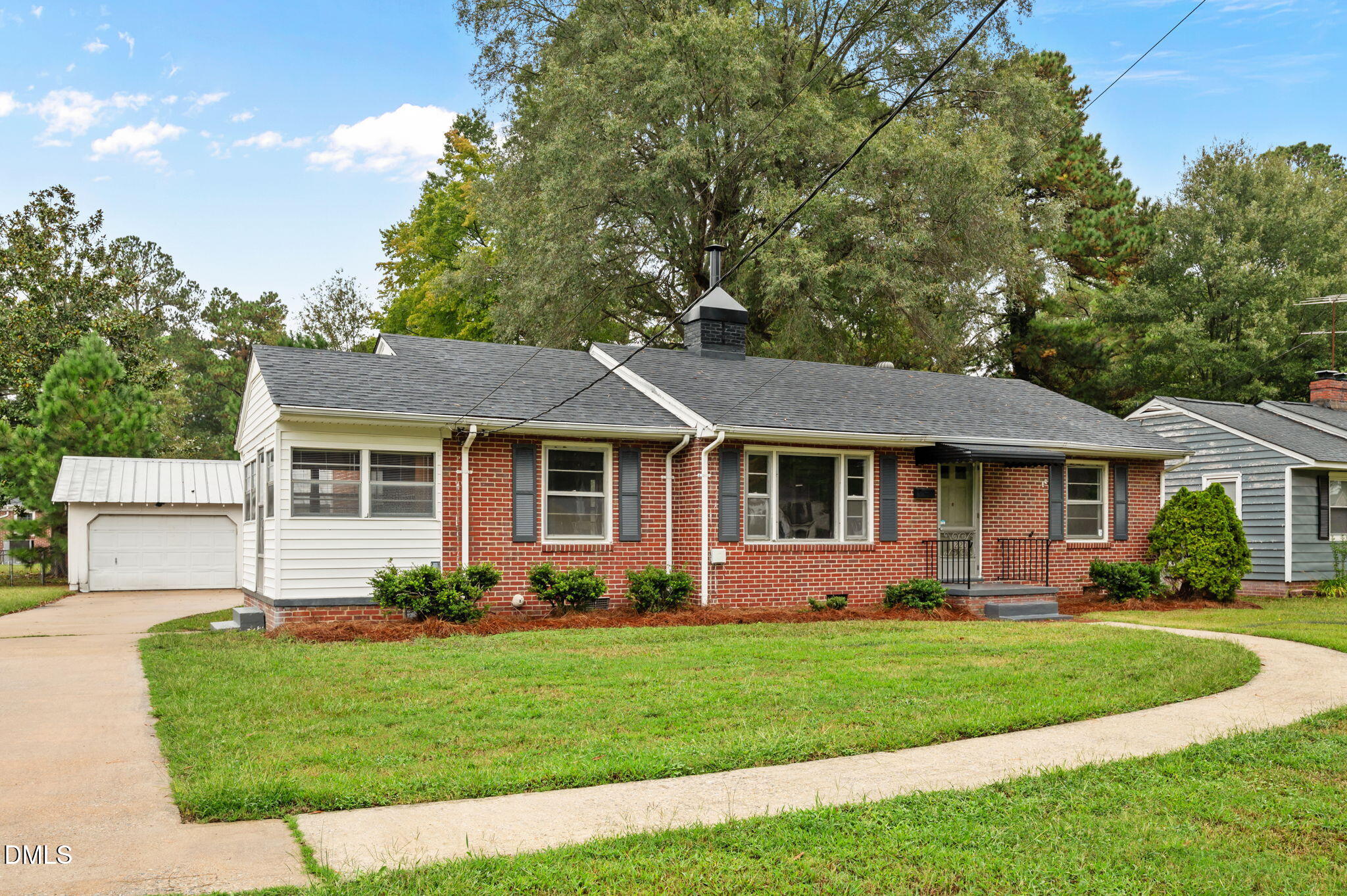 1220 Tarboro Street Rocky Mount, NC 27801 - Photo 2 of 47 a front view of a house with a garden and plants