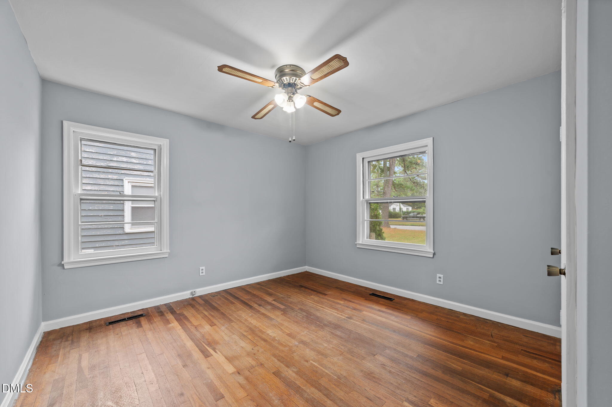 1220 Tarboro Street Rocky Mount, NC 27801 - Photo 32 of 47 a view of an empty room with wooden floor and a window