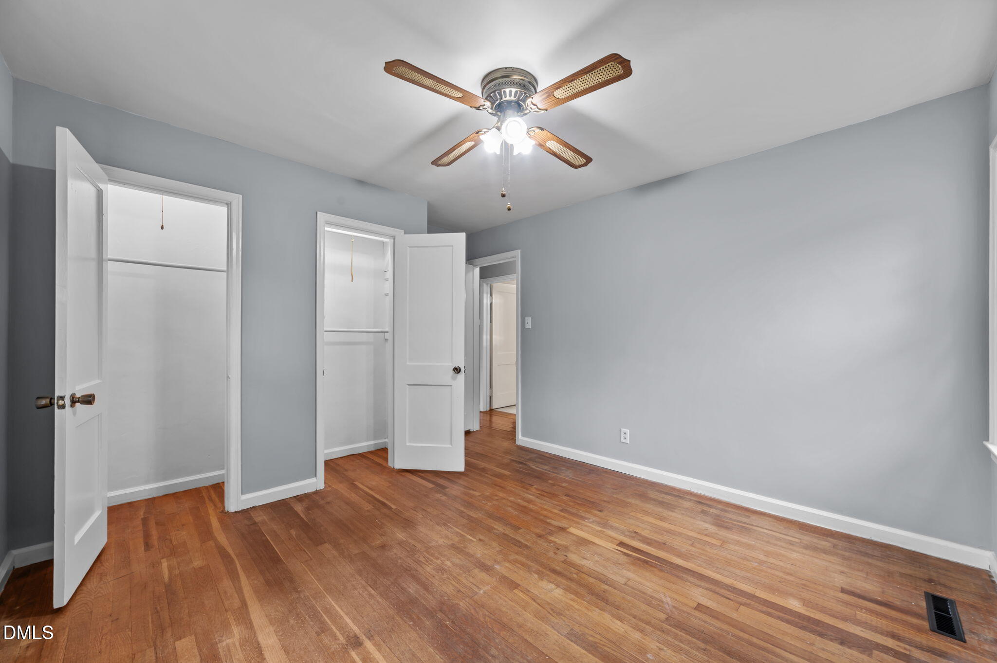 1220 Tarboro Street Rocky Mount, NC 27801 - Photo 34 of 47 an empty room with wooden floor and ceiling fan