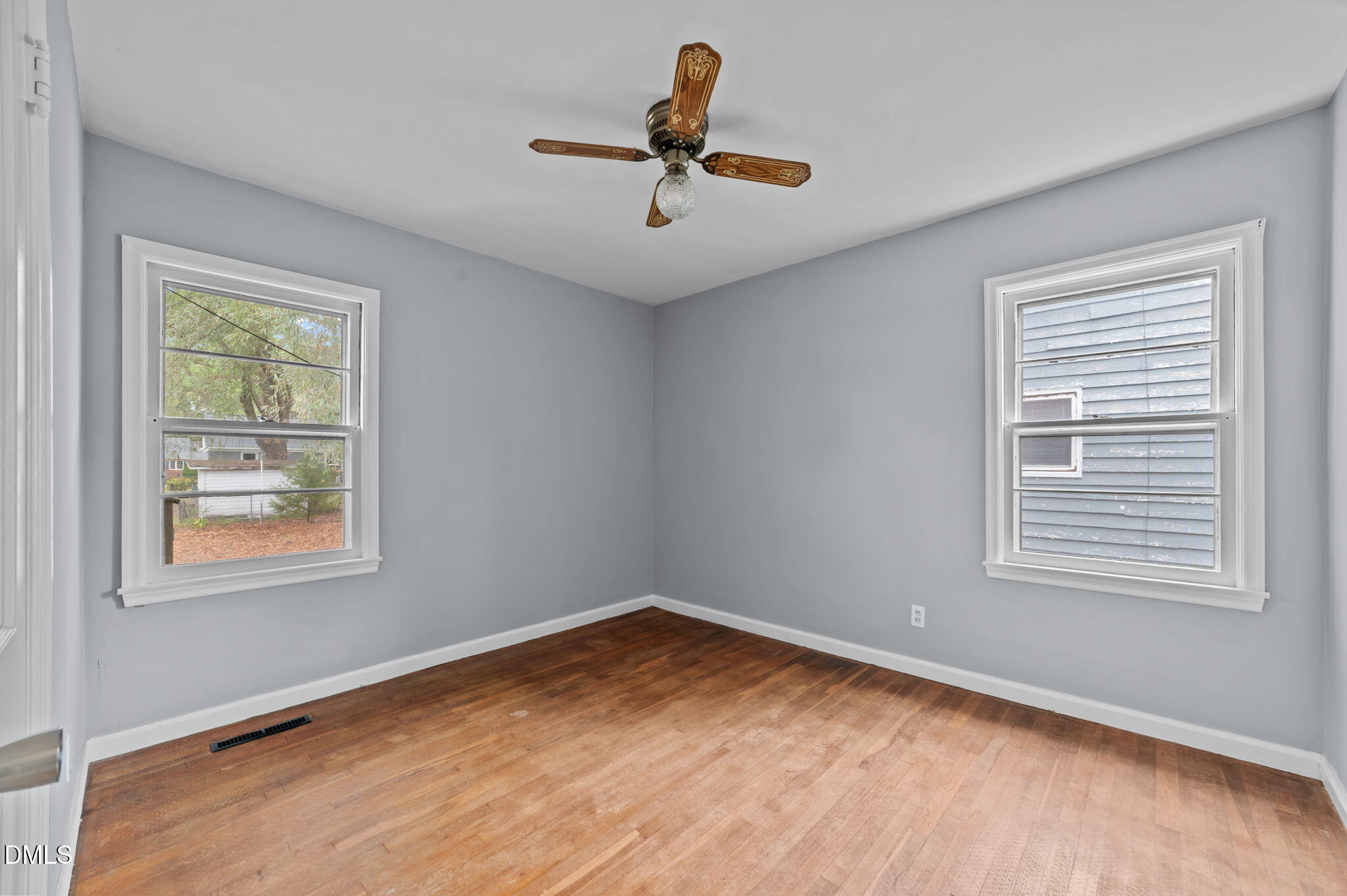 1220 Tarboro Street Rocky Mount, NC 27801 - Photo 35 of 47 a view of empty room with wooden floor and fan